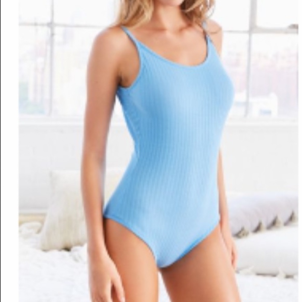 Out from under baby blue ribbed bodysuit